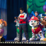 The cast of Paw Patrol live looks out to the audience from the Algonquin Commons Theatre stage
