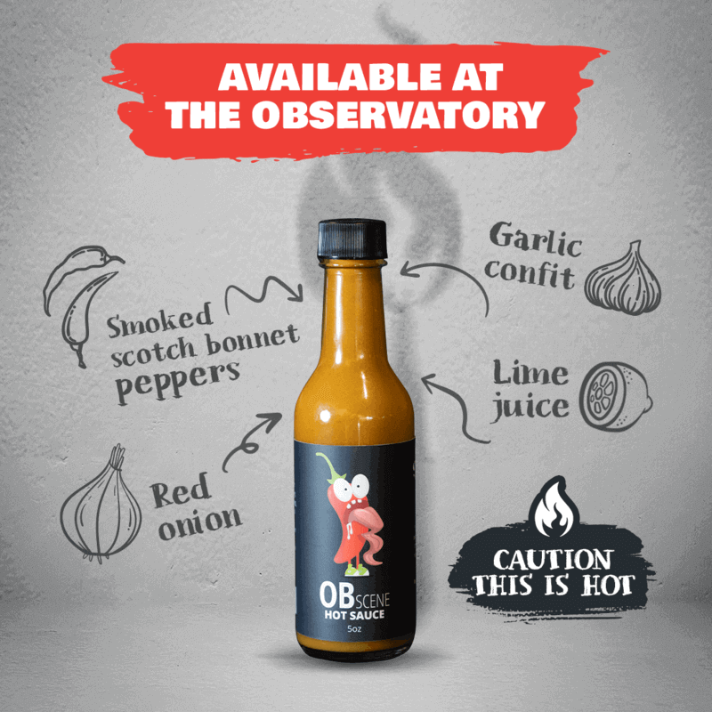 A bottle of OBscene hot sauce showing its ingredients including smoked scotch bonnet peppers, garlic confit, lime juice, and red onion. Caution this is hot!